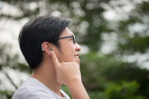 Man outside with hearing aids.